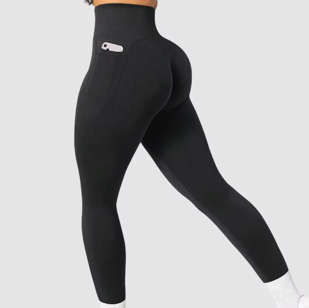 Black balancewise leggings with a logo on and with a pocket detail on a light gray background