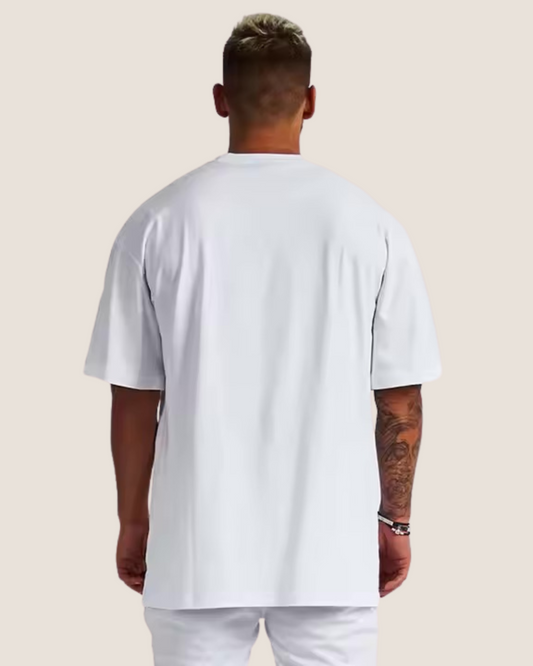 Man wearing a plain white t-shirt and pants on a light beige background