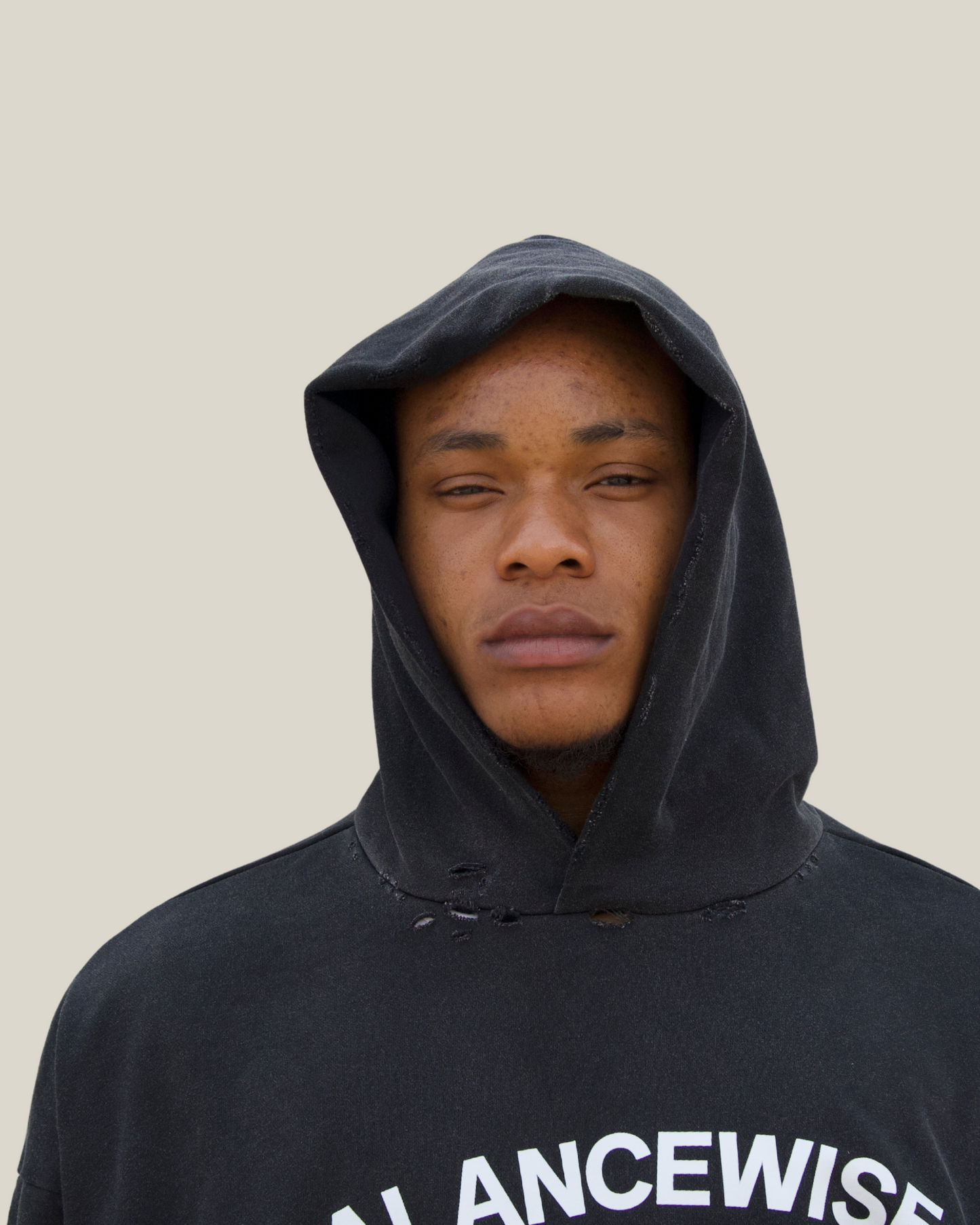 Person wearing a black hoodie with 'BALANCEWISE' text on a plain background