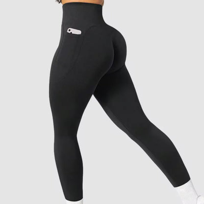Black balancewise leggings with a logo on and with a pocket detail on a light gray background