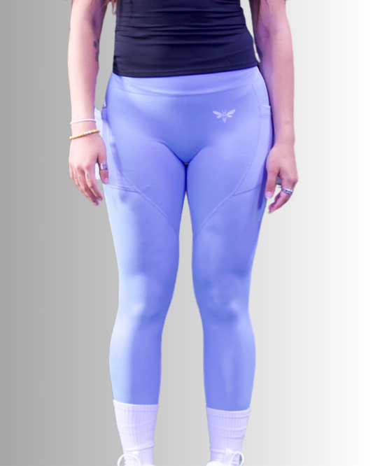 Person wearing  Light Blue balancewise leggings with a balancewise logo on a plain background