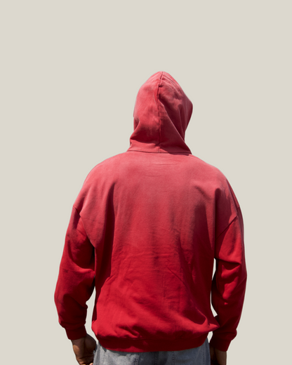 Person wearing a red hoodie from behind on a plain background back balancewise