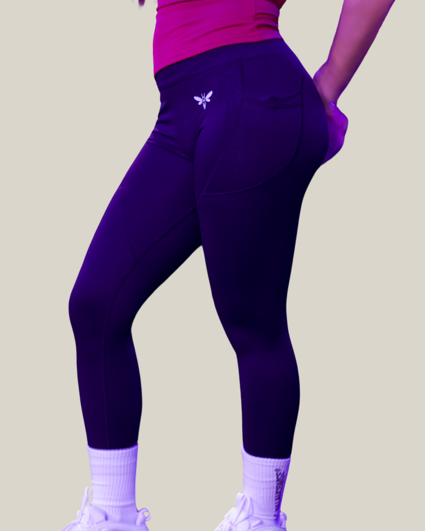 Person wearing navy balancewise leggings with a logo on